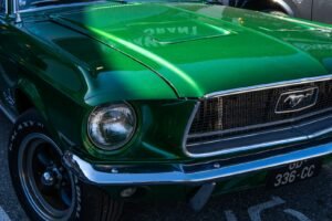 a green mustang car parked in a parking lot